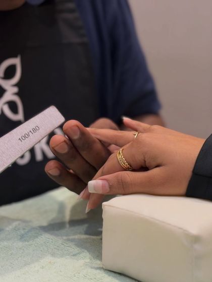It all starts with the prep. I take great care in shaping and filing each nail to create the perfect canvas for a classic French manicure.
