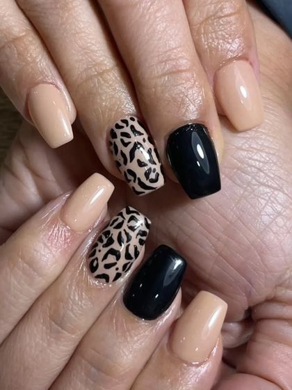 A full view of the leopard print nail art. The combination of nude, black, and animal print is always in style and looks great on this square nail shape.