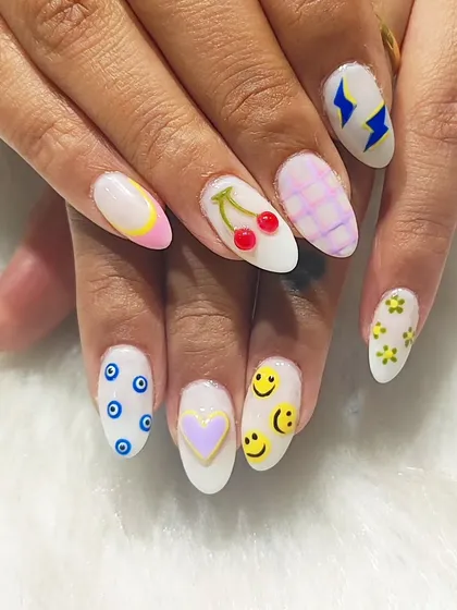 Why choose one vibe when you can have them all? This mismatched set is all about fun, featuring hand-painted cherries, smiley faces, evil eyes, and lightning bolts for a look that’s totally unique.