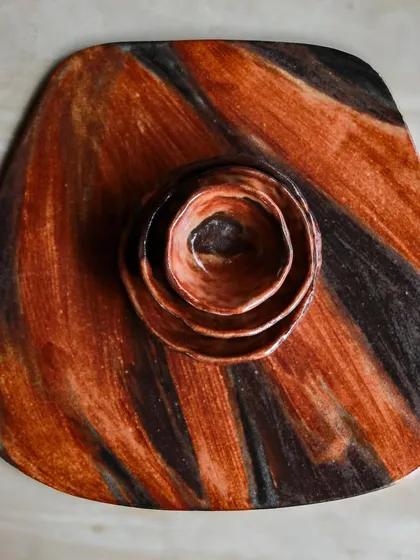 A top-down view of the platter and nested dip bowls. The brushstrokes of glaze create a dynamic, painterly effect.