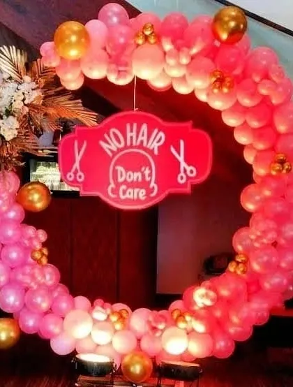 Here is another 'No Hair Don't Care' decoration, this time in pink and gold. This circular balloon arch is perfect for celebrating a baby's mundan ceremony in style.