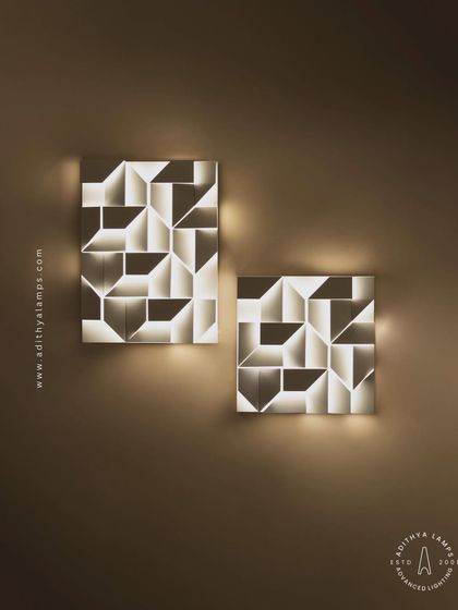 A straight-on view of two geometric wall lights, showing how they can be paired to create a balanced and artistic wall feature. Their soft, back-lit glow is perfect for ambient lighting.