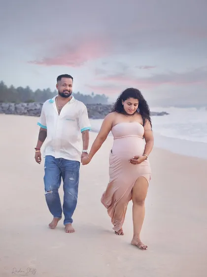 A walk on the beach at dusk creates such a dreamy and romantic atmosphere. The soft pastel sky and gentle waves provide a serene setting for capturing your connection as you look forward to becoming parents.