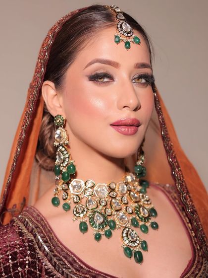 A bridal look that captures the essence of elegance and timeless beauty. The focus is on glowing skin, traditional jewelry, and makeup that feels both classic and fresh.