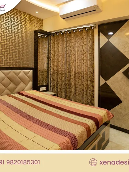 This bedroom features a custom wardrobe with a unique geometric pattern in black and brown laminate. The design is paired with a padded headboard and a wallpapered accent wall, creating a bold and modern look.