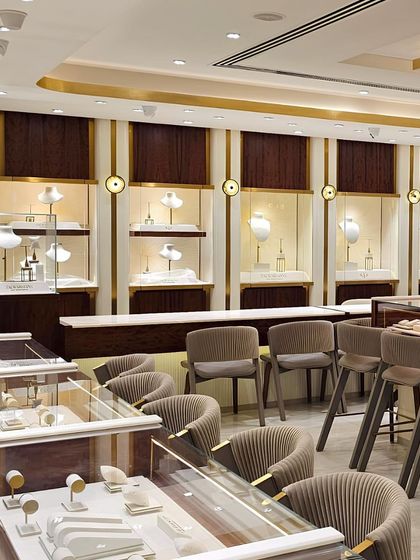 The main sales floor at Talwarsons is designed for comfortable, unhurried consultations. The space is lined with fiddleback mahogany panels and features neutral-toned seating, creating a warm and deliberate material palette that feels both rich and balanced.