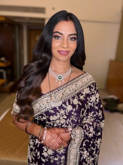 A beautiful portrait in a timelessly elegant saree. The makeup is soft and glamorous, with a focus on defined eyes and a flawless complexion.