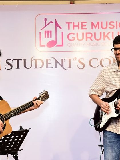 Founder Hitesh Rupani and a student share the stage during a student concert. This image captures the supportive dynamic between our coaches and students, even during a live performance.