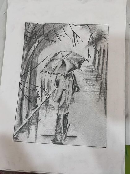 A finished pencil sketch of a person walking in the rain. The student did a great job creating a moody atmosphere.