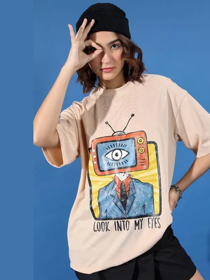 A close-up on the graphic tee, a central piece of this streetwear look. The styling is kept minimal with a simple beanie to let the artwork on the shirt stand out.