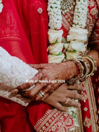 A close-up of the couple's hands during a wedding ritual. The bride's mehendi is a beautiful detail in this intimate shot, symbolizing their union.