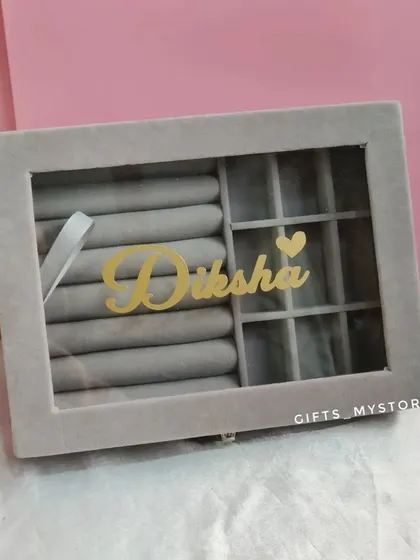 A personalized jewelry organizer with her name in gold. It's a stylish and practical gift that she can use every day.