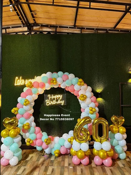 This semi-circle balloon arch was designed for a 60th birthday party. The pastel colors and gold accents, along with the large foil numbers, create a cheerful and celebratory photo backdrop.