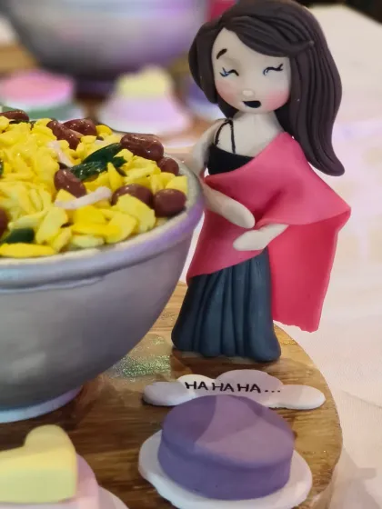 A close-up of one of the figurines from the "Poha" cake, representing one of the comedians at the event.