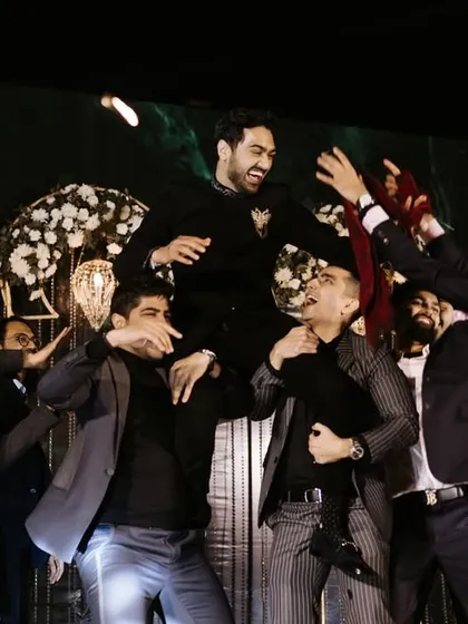 The groomsmen lifting the groom in celebration. We incorporate these high-energy moments into our choreography.