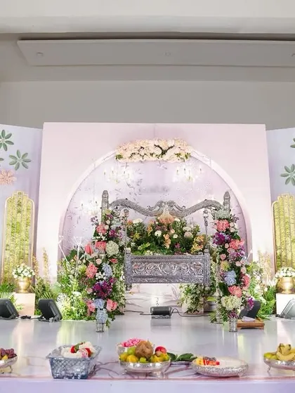 A slightly different angle of the naming ceremony stage, showing the beautiful layers of flowers and greenery. The soft lighting and delicate details made this a perfect setting to welcome a new life.