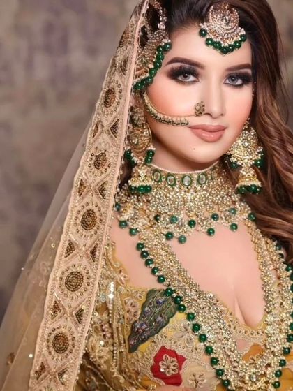 A grand bridal look with a heavy, layered green jewellery set against a yellow and green lehenga. Perfect for a mehendi or haldi ceremony.