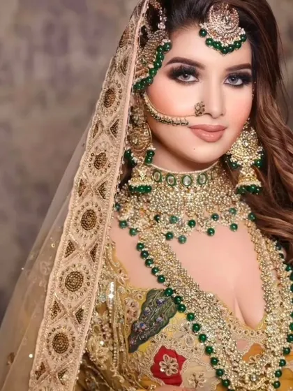 A grand bridal look with a heavy, layered green jewellery set against a yellow and green lehenga. Perfect for a mehendi or haldi ceremony.