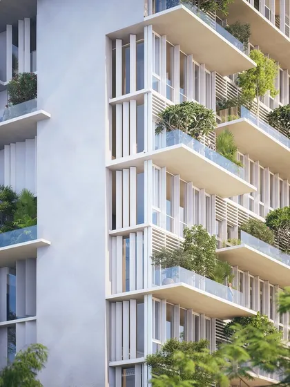 This apartment facade is our climate-responsive philosophy in practice. Deep, staggered balconies provide shade to the floors below, and elegant aluminum slats filter the harsh sun, ensuring the living spaces within remain cool and comfortable without sacrificing light.
