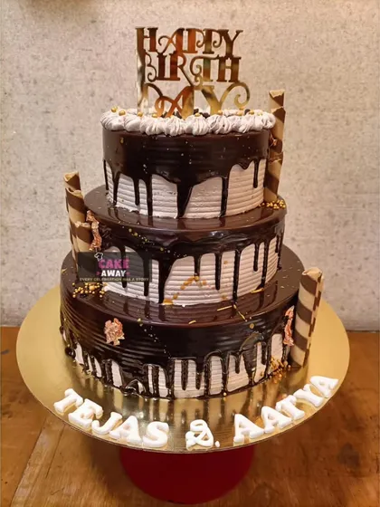 A grand three-tier chocolate drip cake. This towering creation is perfect for large birthday parties or events, combining classic looks with indulgent flavor.