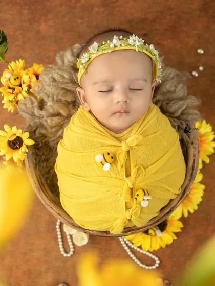 This little honeybee is as sweet as can be! The yellow wrap with tiny bee details and sunflower props creates an adorable and unique theme.