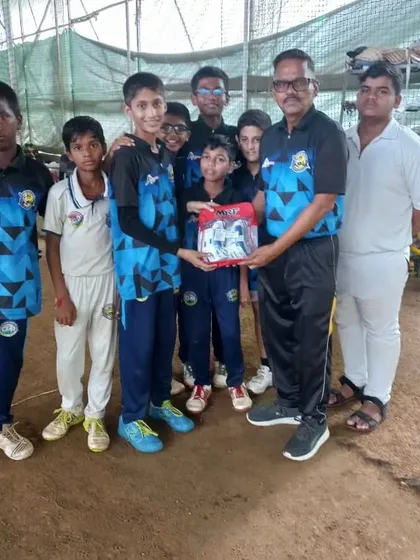 The team presenting a birthday gift to Tanish. We support each other on and off the field.