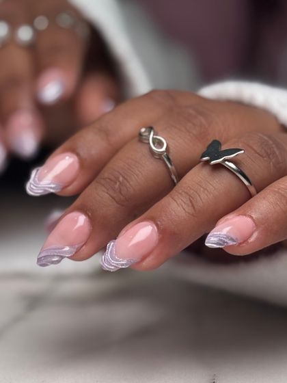 Another view of the soft purple marble and glitter tip nails. This look is ethereal and perfect for someone who loves a subtle touch of glam.