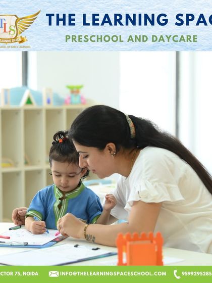 A teacher provides one-on-one guidance to a student in our thoughtfully designed classroom. This nurturing atmosphere helps build confidence and a love for learning.