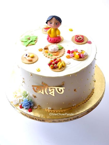 A special cake for a Bengali Annaprasan, or Rice Ceremony. This Chocolate Truffle cake is decorated with handcrafted, edible elements representing the traditional items used in the ceremony.