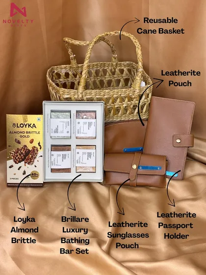 For a more rustic and eco-conscious feel, I offer hampers like this one. It combines a reusable cane basket with premium leatherette accessories like a passport holder and a sunglasses pouch.