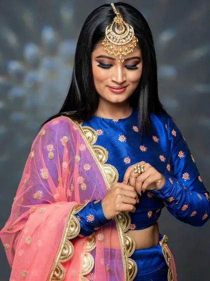 Another angle showing the flawless eye makeup and the intricate design of the jewelry.