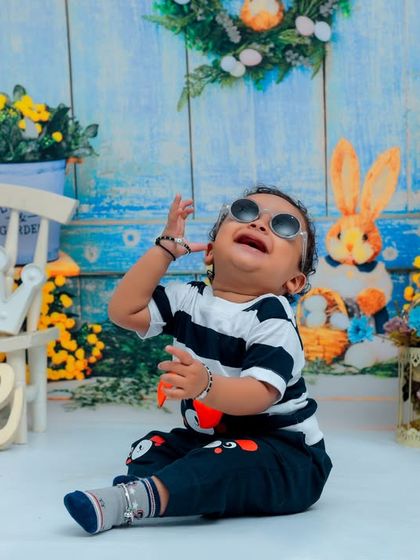 The coolest one-year-old on the block! This little boy is rocking sunglasses and a big smile during his fun, rabbit-themed first birthday photoshoot.
