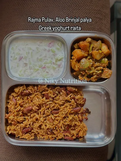 A simple yet satisfying meal of rajma pulav, aloo brinjal palya, and Greek yogurt raita. Combining rice with kidney beans makes it a complete protein source.