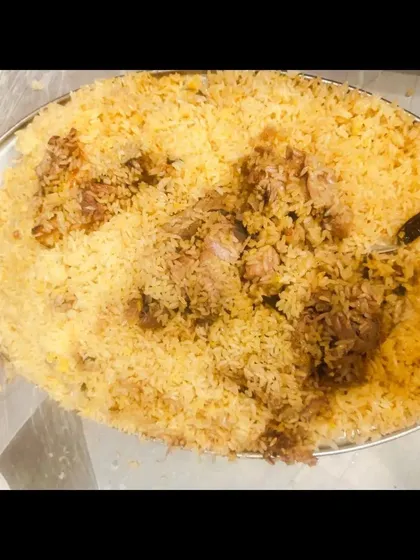 A full platter of my mutton biryani, with generous pieces of meat mixed in.