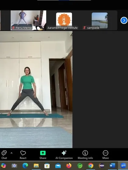 A participant holds a wide-legged stance during the weight management workshop. This pose, Prasarita Padottanasana, strengthens the legs and stretches the spine and hamstrings, promoting flexibility and balance.