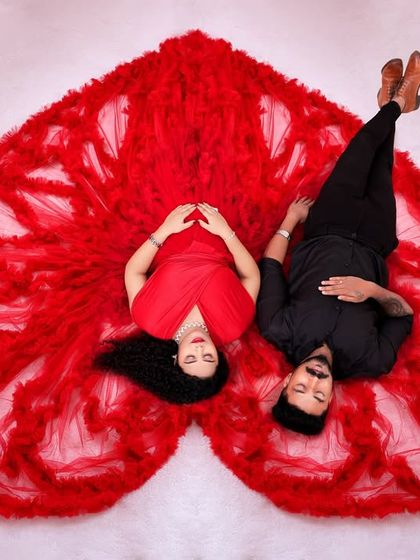 Our signature overhead "sleeping pose" with a couple, featuring a red ruffled gown arranged in a heart shape.