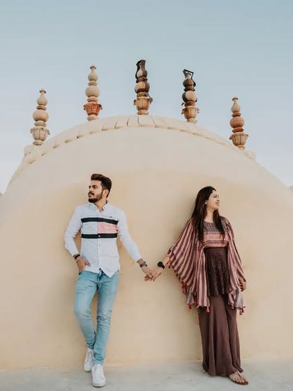 A stylish portrait on the rooftop of a heritage building in Jaipur. The unique architecture of the domes provides a stunning and unconventional backdrop.