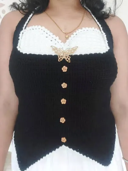 I love creating pieces that are both elegant and unique, like this Belladonna corset-style top. The contrast of the white bustier against the black body, complete with delicate button details and a butterfly charm, makes for a truly special garment.