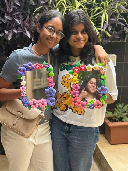 Two friends with their finished clay mirrors. One even has a photo in it already. It's a great way to frame your favorite memories.