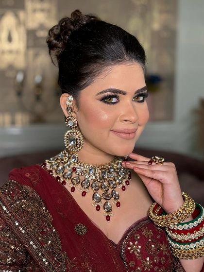 A close-up portrait of this bride, with a focus on her classic smokey eye and the intricate details of her polki jewelry.