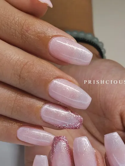 A pretty pink set featuring a V-french design on some nails, filled with a shimmery glitter polish. This was done on temporary extensions.