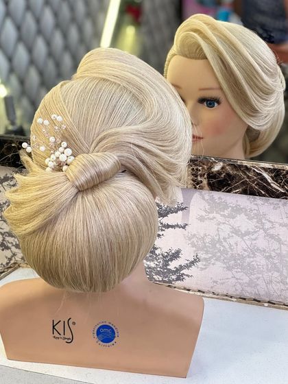A still shot of the elegant low bun with a clean front variation.