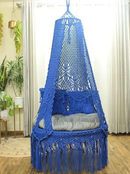 A single seater swing in a vibrant royal blue. This piece is perfect for adding a bold statement to your decor, and it's available at a great price.