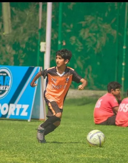 A player dribbling with purpose during a U13 match at the Pride Cup.