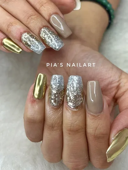 A bold party look combining gold chrome, silver and gold glitter, and a solid nude accent nail.