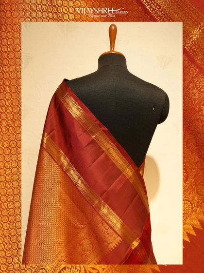 A rich maroon Kanjivaram with a wide gold zari border, a timeless piece for any bridal trousseau.