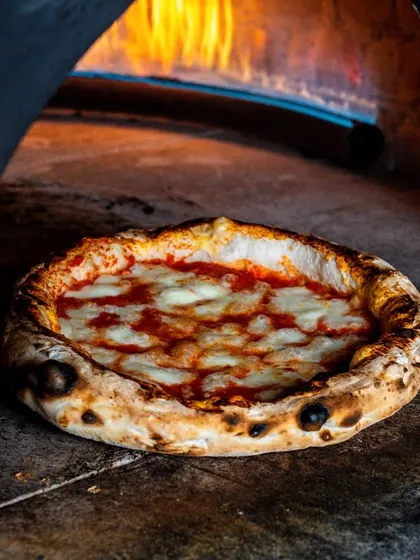 There's nothing like a pizza fresh from a wood-fired oven. I focused on capturing the intense heat, the perfectly charred crust, and the bubbling cheese to convey that unmatched flavor and authenticity.
