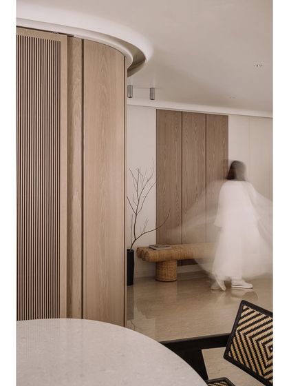 A ghost-like motion shot in the entrance corridor, emphasizing the home's role as a serene, flowing space for living.