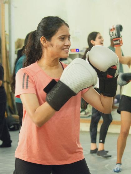 A member smiling and ready to throw some punches during the workshop.