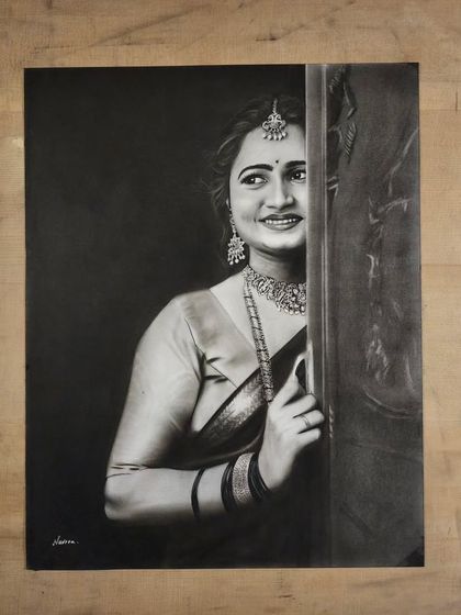 A stunning portrait of a woman in traditional attire, with a dark background that makes her features and jewelry stand out.